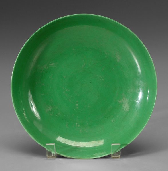 Chinese green-glazed bowl,: exterior with incised [bajixiang] (Buddhist symbols), base with old labels, blue six-character mark for Yongzheng (1723-1735) and of the period, 1-5/8 x 8-1/8 in. Two rim cracks (largest 1-1/2 in.), o