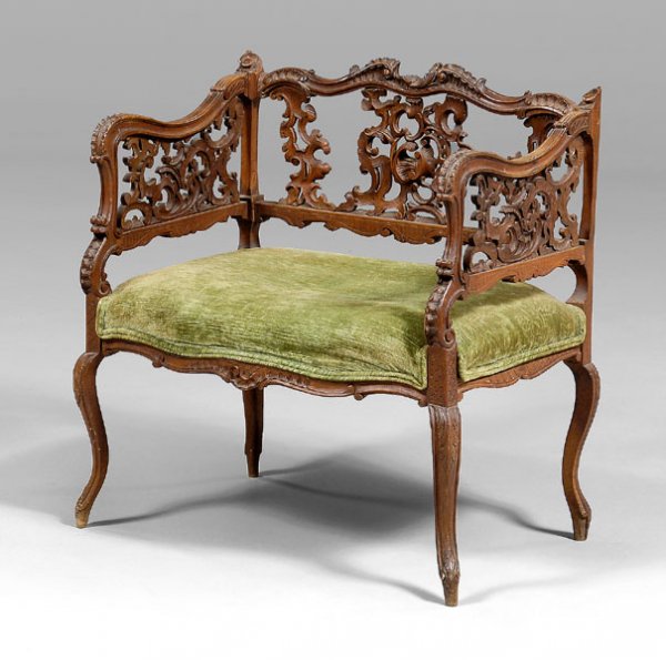 Italian rococo style window bench,: slipper chair or window bench with [rocaille-]carved back and arm supports on delicate carved legs, walnut throughout, green velvet seat, Italian, late 19th century, 27-1/2 x 24-1/4 x 18 in. Break and