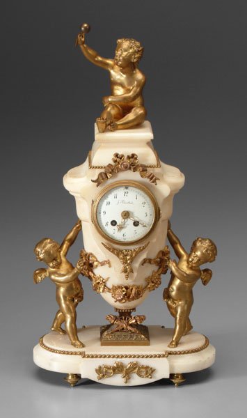 French marble clock with cupid mounts,: central urn with [putto] holding a baton, central urn with festoons flanked by two cupids, face marked "J. Baurbier(?) Paris", brass works, key wind, late 19th/early 20th century, 19-1/2 in. One cupid