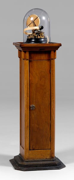 Universal tickertape machine,: under glass dome, marked on brass base "Universal Ticker 3-A/22 Ohms", serial number 4951, attached metal tag "36A", 10 in., original walnut-veneered pedestal with stepped steel base, door, 54 x 18 x 