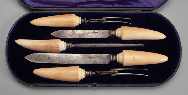 Cased bone-handle carving set,: English silver ferrules with marks for Mappin & Webb, Sheffield, 1907: two knives, two forks and sharpener, 10-3/4 in. to 15 in., in pasteboard case, (five pieces). Silver with dents, discoloration to