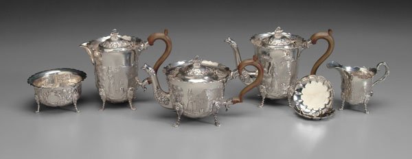Five-piece Irish tea service:: repousse and engraved farm scenes with cows and maidens, swan finial, lion and paw feet, scrolled wooden handles, 6-3/4 in. coffeepot, matching milk pitcher, teapot, creamer and sugar, marks for Royal