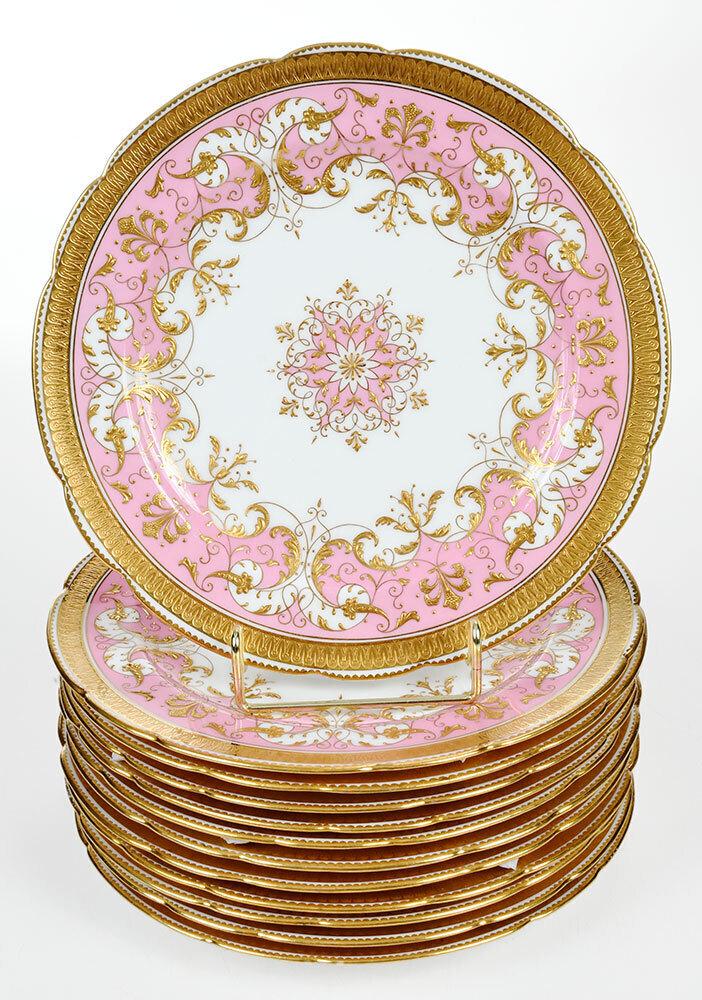 12 Mintons Pink and Raised Gilt Dessert Plates: British, pink and white ground, scalloped edges, raised gilt decoration and borders, Mintons marks to undersides, marked "Manufactured for/Caldwell & Co, 8-7/8 in. diameter Provenance: Estate of Ella 