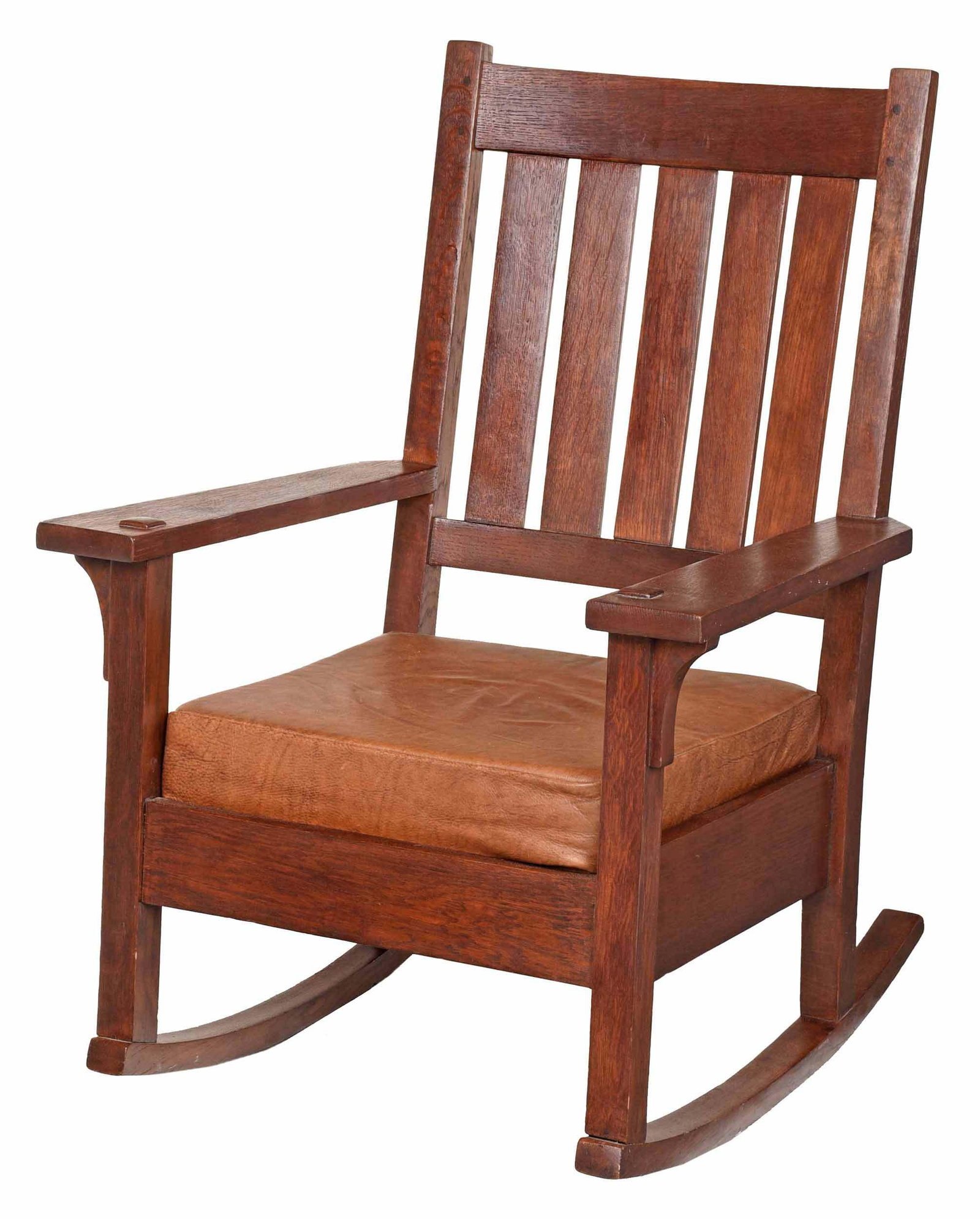 American Arts and Crafts Oak Rocking Chair: possibly Stickley, early 20th century, oak throughout with five slat back, brown leather upholstered loose seat cushion, 37-3/4 x 27-1/4 x 28 in. Provenance: Private Collection