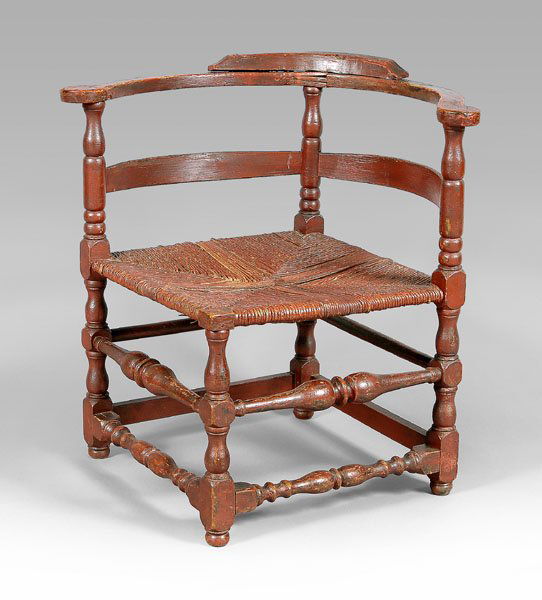 Important William and Mary corner: chair, massive scale, maple and other mixed woods, shaped arms, ring and baluster turned legs and stretchers, rush seat, probably New London County, Connecticut, circa 1740, early red-painted surface,