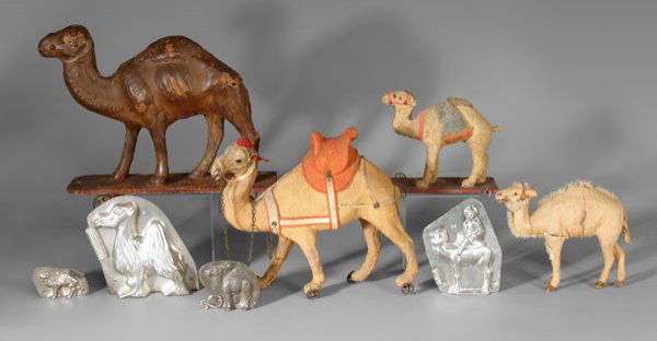 Four camel pull toys, four molds: four hinged metal camel molds, tallest with rider on back and marked "Anton…Dresden"; next largest with illegible German mark; smallest marked "Riecke"; one unmarked, 2-1/8 in. to 6 in., [good condi