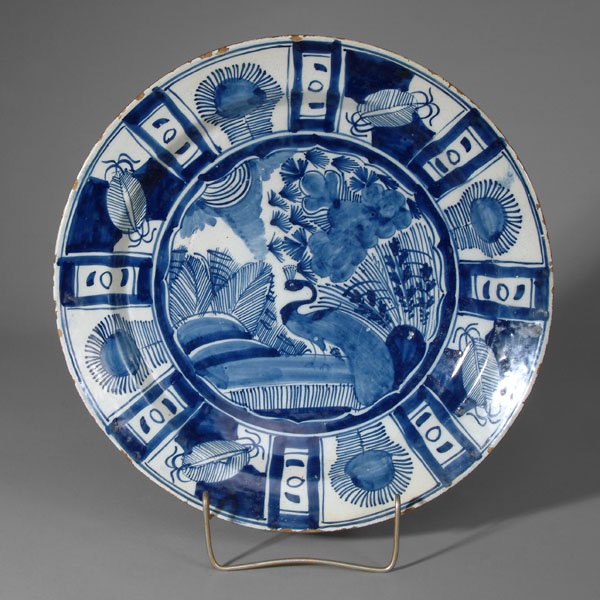 Delft shallow bowl,: chinoiserie style decoration with [Wan Li] border, central peacock in garden setting, attributed to the "Kaapsche Schotel" and possibly "De Metalen Pot" during the period of Lambert van Eenhoorn, Dutc