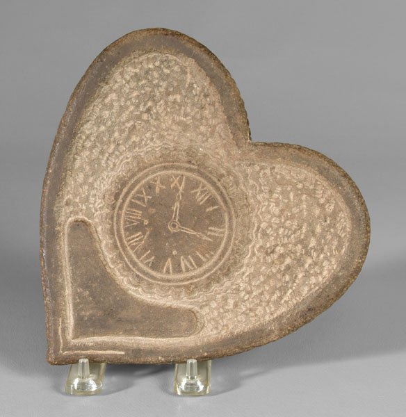 Carved stone sailor's Valentine,: one side with old brown paint over interlocking cross and anchor with carved rope border, other side with watch, hands set at 12 minutes after 11:00, possibly lava, Nantucket, Massachusetts, 1870-1890