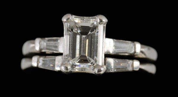 Diamond and platinum wedding set: engagement ring set with central emerald-cut diamond, estimated weight 1.31 cts., color I, clarity VS1, flanked by two baguette-cut diamonds; conforming wedding ring set with two cut-cut diamonds, tot