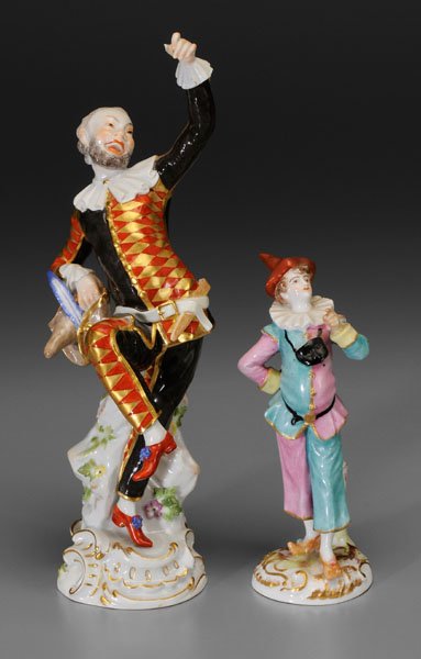 Two porcelain figures: harlequin holding hat with blue feather, blue crossed swords Meissen mark, incised under glaze "3025" "102", 20th century, , 10 in., [loss to slap stick, loss of jug and thumb;] harlequin with protrud