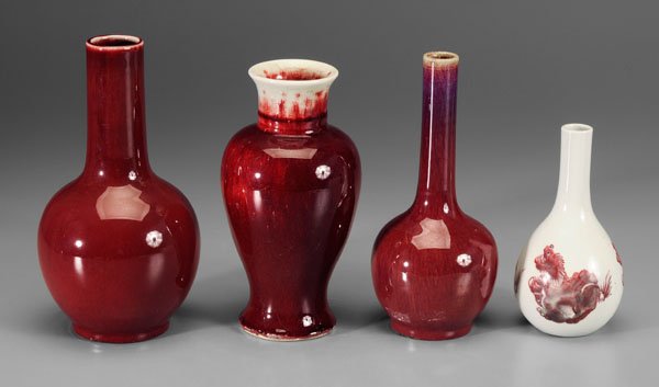 Four Chinese copper-red glazed vases:: bottle vase, three copper-red Buddhist lions on a white ground, base with blue six-character Guangxu mark (1875-1908) and of the period, 7-1/4 in.; bottle vase, white-glazed crackled base, 10-1/8 in.;