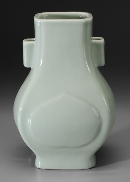 Chinese celadon [hu] base,: heavy quadrilateral body with open angular handles, canted corners at rim, molded peach-form panels, base with blue Guangxu mark (1875-1908) and of the period, 11-1/2 in. Foot ring with three chips (l