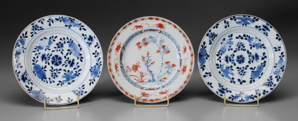 Three Chinese export plates:: one with Imari interior with bamboo and other plants, 8-3/4 in., [minor flaws and wear;] two blue and white, interiors with fruit and flowers, 8-7/8 in., [one with rim chips, other with 3/4 in. rim cr