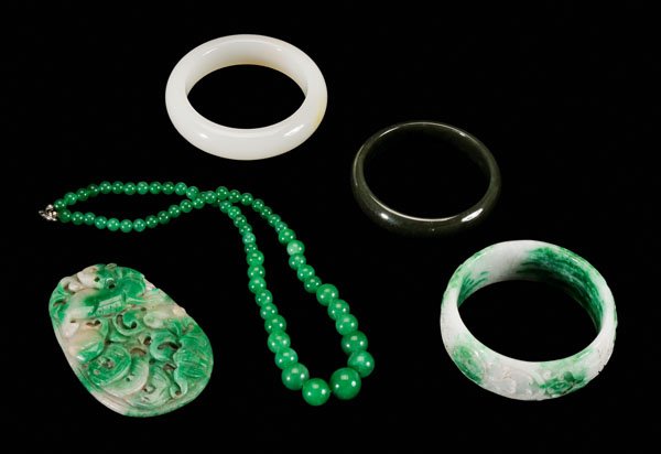 Five pieces Chinese stone jewelry:: strand of graduated green hardstone beads, 18 in.; olive green hardstone bangle, 2-7/16 in. interior; green and white hardstone bangle carved with peaches, [lingzhi,] bats with coin, 2-5/8 in. interio