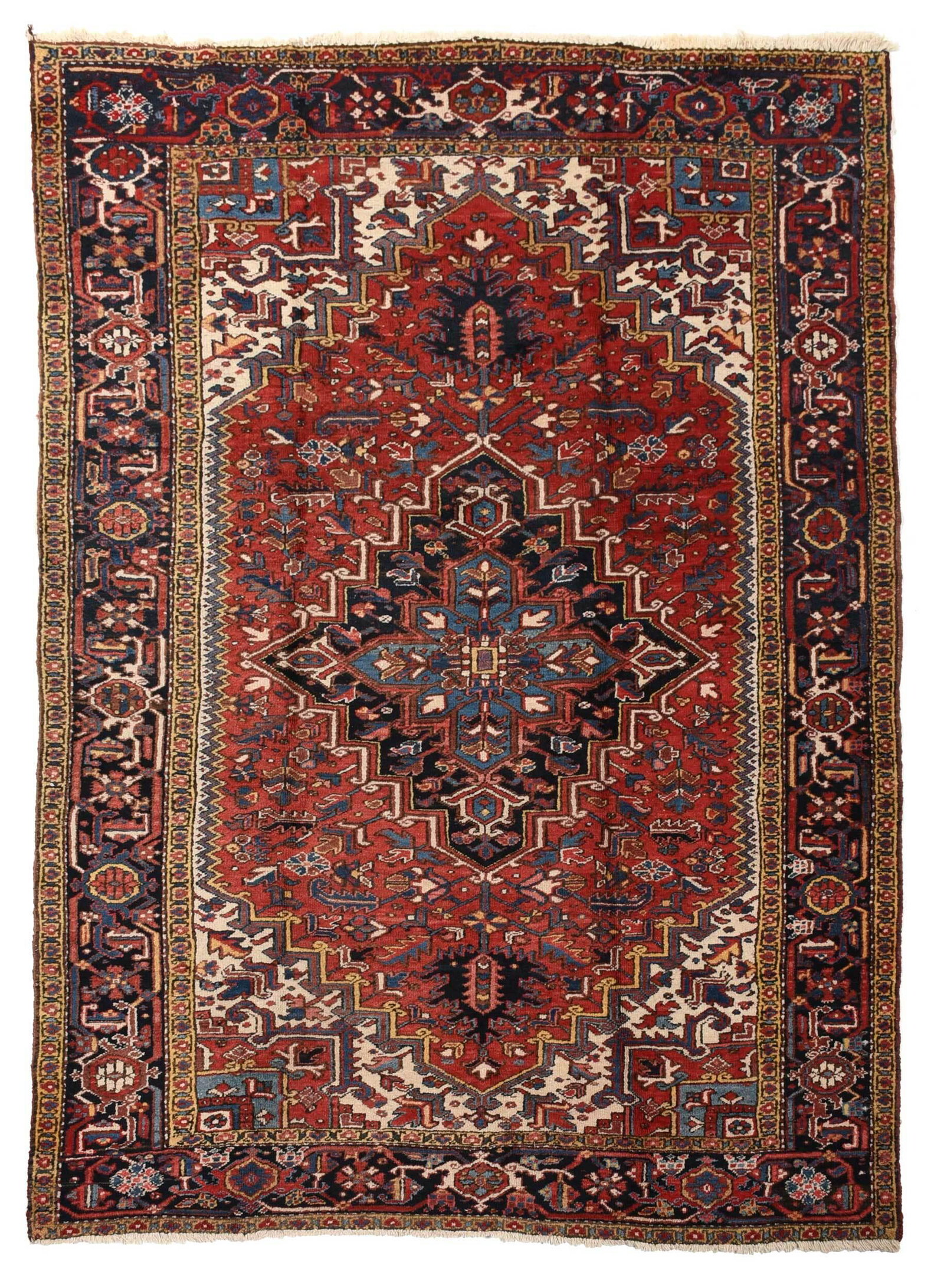 Heriz Carpet: mid 20th century, blue polygonal central medallion, red field with serrated sides, stepped spandrels, yellow border, 9 ft. 7 in. x 6 ft. 5 in.ÿ , Provenance: The Ann and Joel Finn Collection