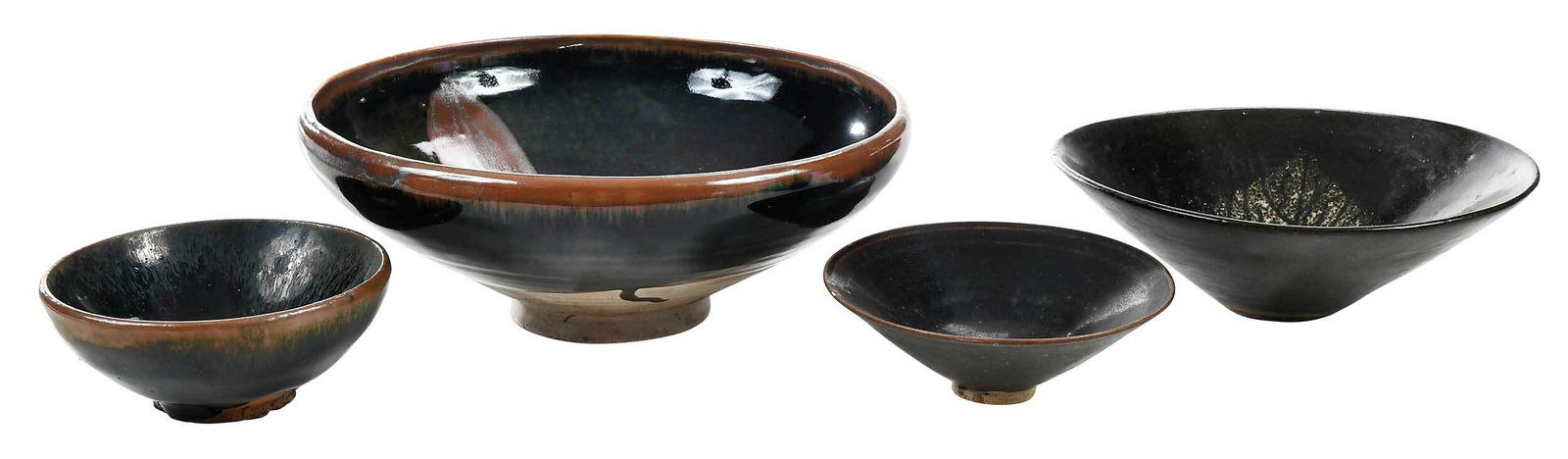 Four Chinese Jian Type Glazed Bowls: possibly Song dynasty or style, jizhou type bowl,ÿthe interior decorated with a contrasting buff colored leaf resist, 2 x 6 in.; cizhou type bowl, the interior with brushed iron oxide russet splashes