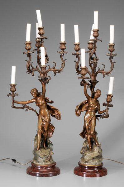 Pair Art Nouveau style candelabra::: spelterware with faux red marble bases, each with woman in flowing garment holding six-arm candelabra, one with rope at her feet, one with fish at her feet, marked on sides "Math. Moreau", 34 in. to t