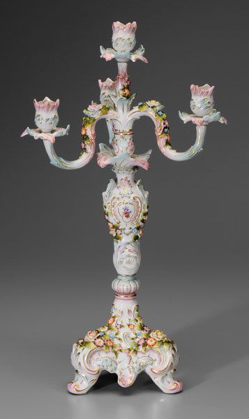 German porcelain candelabrum: rococo style, hand-painted and applied flowers and foliage, gilt highlights, underglaze blue crossed sticks mark, possibly Schierholz, late 19th/early 20th century, 21-7/8 in. Good condition, scattere