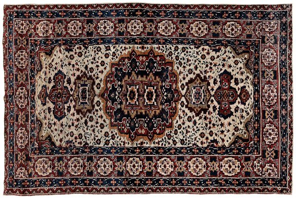 Persian rug,: central medallion with pendants on ivory ground, probably Baktiari, 5 ft. 3 in. x 8 ft. 7 in. Pile varies from none to low, 1/2 in. loss at each end with later binding, reselvedged, scattered areas of