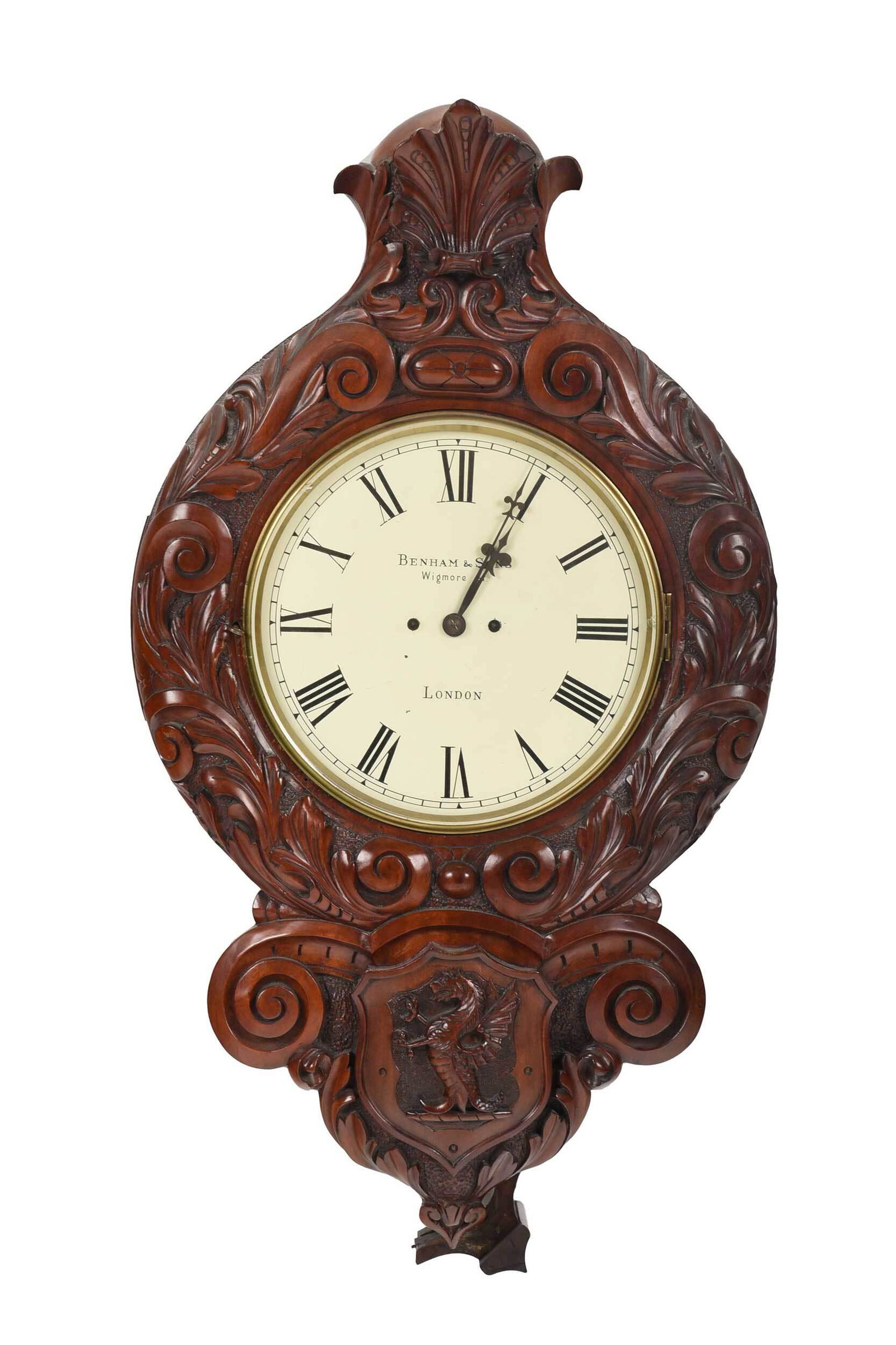 Benham & Sons Carved Mahogany Wall Clock: British, 19th century, hinged front glass panel over circular painted dial with Roman numerals marked "Benham & Sons/Wigmore St./London", in scroll carved mahogany case, lower section with escutcheon 