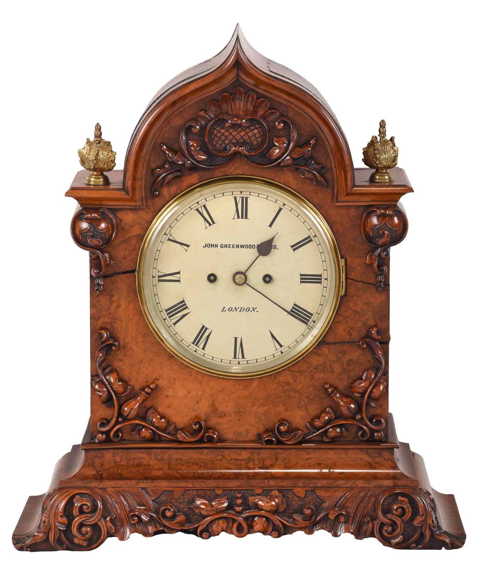 John Greenwood and Sons Carved Burlwood Shelf Clock: British, 19th century, hinged glass panel over circular painted dial with Roman numerals marked "John Greenwood & Sons/London", set in carved arched burlwood case with foliate decoration and two bronz