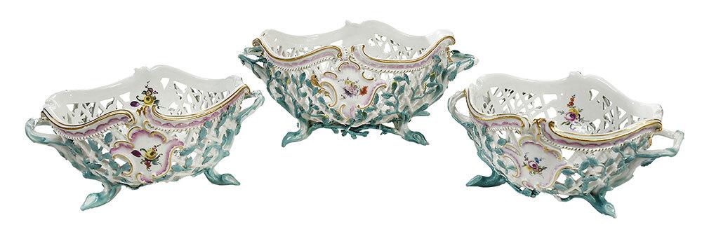 Assembled Set of Three Meissen Porcelain Baskets: German, 19th/20th century, each reticulated basket with molded vines forming feet and handles, hand painted floral clusters, gilt accents, two with underglaze blue crossed swords mark, largest 5-1/2 x