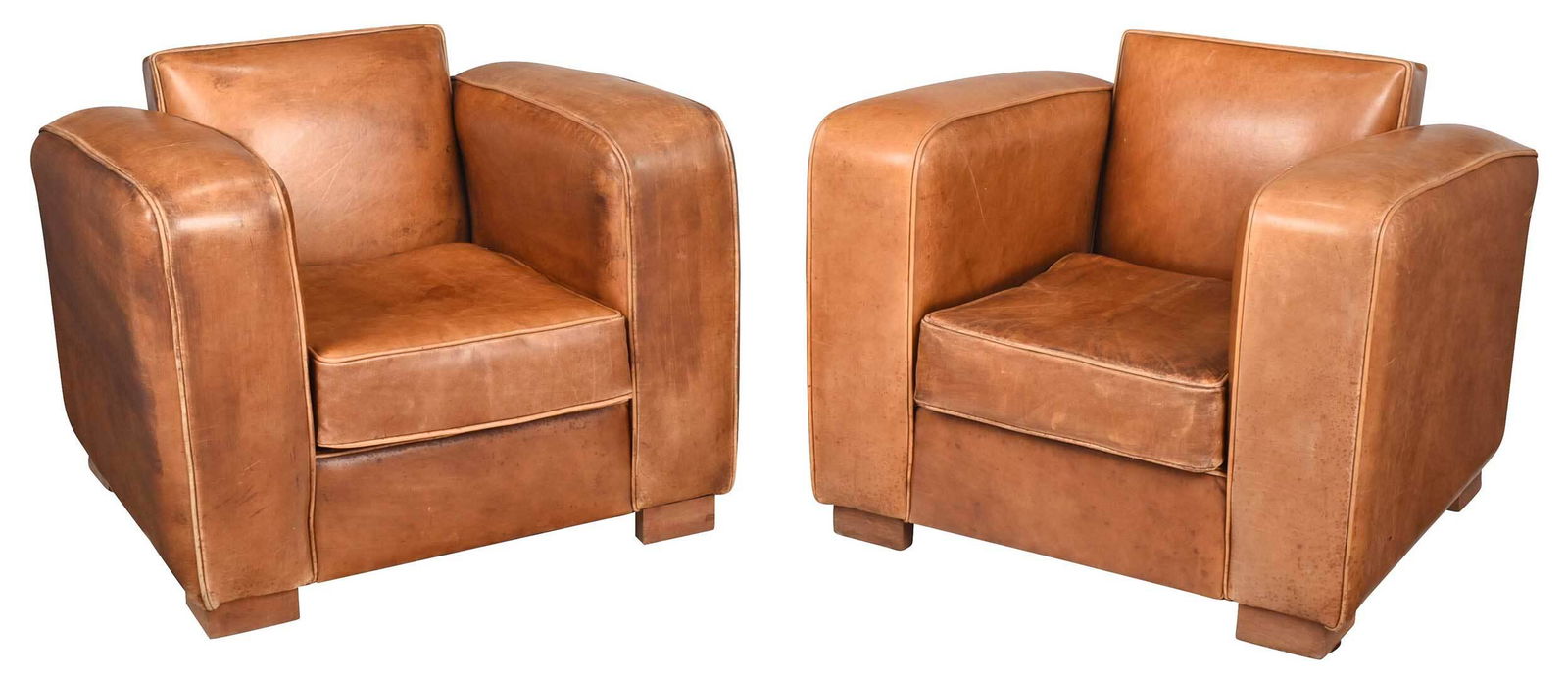 Pair Art Deco Leather Club Chairs: circa 1930, brown leather throughout with loose cushions, brass tacking to back panels, 27 x 35 x 33 in. Provenance: Private Georgia Collection