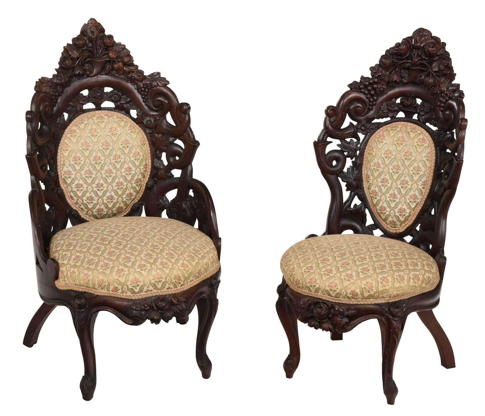 Pair American Rococo Revival Rosewood Side Chairs: attributed to John Henry Belter, mid 19th century, comprising one arm and one side chair, each with floral, cornucopia, oak leaf, and acorn carved back, upholstered backs and seats, floral carved seat