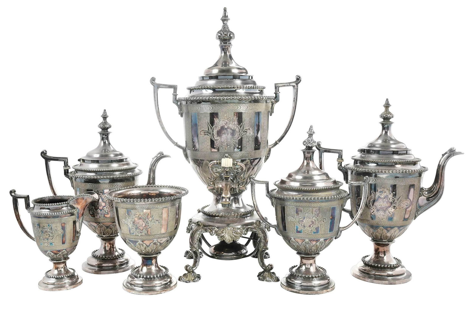 Six Piece Silver Plate Reed and Barton Tea Service: American, 20th century, engraved urn forms, composite spacers, monogram, all with marks for Reed & Barton, 18 in. hot water urn with matching coffee pot, teapot, covered sugar, creamer, and waste Prov