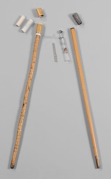 Two Walking Sticks: one with silver-plated cap with figures, opens to compartment holding a syringe, horn tip, possibly Middle Eastern, 34-5/8 in., [old separations and losses;] one with cap holding two documents, dated 