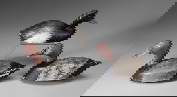 Three Canvasback Decoys: hollow bodies, glass eyes, original weights: two Chris Smith, drake, attached label "Muskrat farm decoy", 16-1/2 in.; hen, 15 in., [both with old repaint, shot marks, paint loss, normal wear and abras