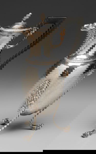 Silver Coffeepot: French, early 19th century, amphora body, eagle-head spout, palm-and-dart borders and finial, raised paw feet with acanthus terminals, square wooden handle, French maker's mark "MVC" with anchor in di