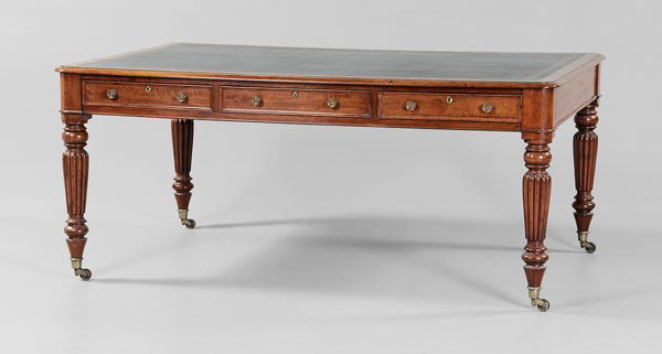 William IV Partner's Desk: British, 19th century, figured mahogany, top set with green leather writing surface, each side fitted with three dovetailed drawers with oak linings, turned and reeded legs and brass casters, 31 x 72 
