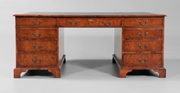 George III Style Partner's Desk: modern, yew wood-veneered top set with tooled black leather, each side with three drawers, two pedestal bases, each with three drawers on one side and cabinet door with false triple front on reverse, 