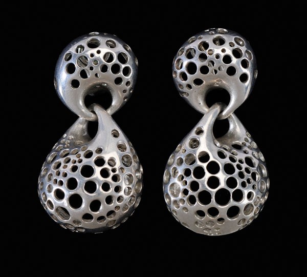 Angela Cummings Sterling Earrings: American, 1991, linked pierced pod forms, signed "1991 CUMMINGS", omega pierced clips, 2 x 1 in., wear and some scratches Provenance: Private Collection, Asheville, North Carolina Angela Cummings bega