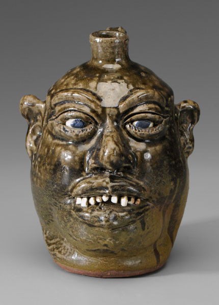 Lanier Meaders Face Jug: Georgia, 20th century, stoneware with runny medium olive glaze, ceramic teeth, marked on base "Lanier Meaders" (White County, Georgia, 1917-1998), 9-1/4 in., excellent condition Provenance: North Caro