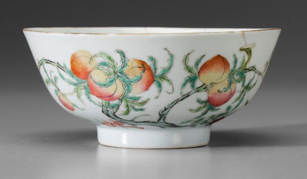 [Famille Rose] Porcelain Bowl: Chinese, early to mid 20th century, branch with nine peaches, lingzhi fungus, two bats, base with iron-red Shen De Tang Zhi mark, 2-3/4 x 6-1/4 in., staple repairs, minor glaze chip on rim Provenance: