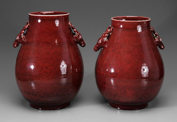 Two Copper-Red [Hu] Porcelain Vases: Chinese, modern, deer head handles, white rims, rich flecked strawberry glaze, 17-3/4 in., [foot chips (largest 1 in.),] and 19 in., [minor foot chip]