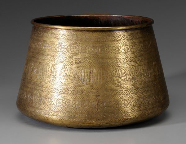 Mamluk Revival Brass Bowl: Syrian or Egyptian, late 19th/early 20th century, angled sides with rolled rim, rows of etched patterns with rondels and lozenges containing script, 9-3/4 x 15-1/2 in., scratches and wear to base Prov