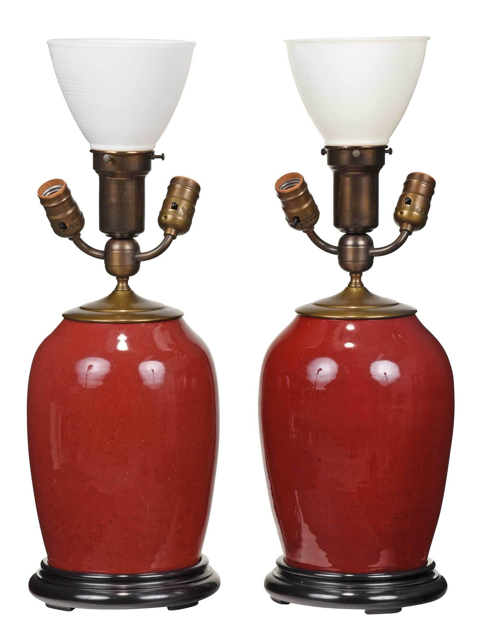Two Chinese Sang de Boeuf Jars Mounted as Lamps: ovoid forms with deep red glaze, mounted to painted wood bases, each jar approximately 10 in., 22 in. to top of glass globes Provenance: Private Bluffton, South Carolina Collection