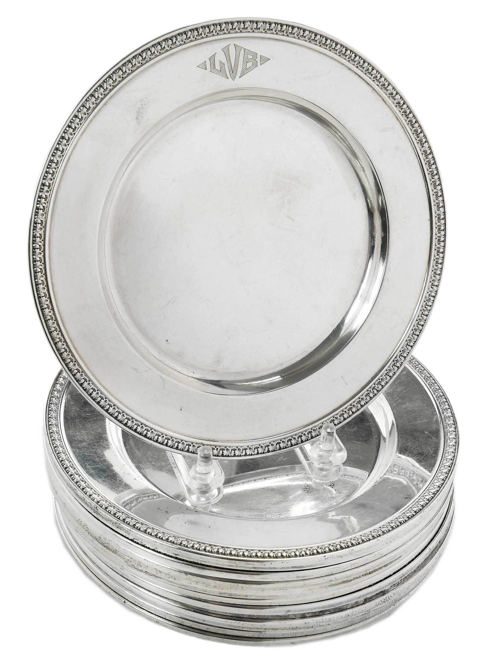 Fourteen Sterling Bread and Butter Plates: American, 20th century, wound with acanthus border, monograms, all with marks for International, "599-1", 42.34 oz. T., 6-1/2 in. Provenance: From the Estate of T. Kenneth and Karin Ellis, "Stepping S