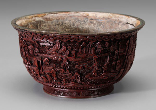 Cinnabar Lacquer Bowl: Chinese, possibly Qianlong period (1735-1795), deep bowl with everted rim, tall foot ring, scholars and attendants within courtyards, brass rims, base with rectangular brass cartouche with six-charact