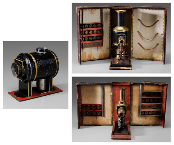 Three Magic Lanterns: German, late 19th/early 20th century, brass and painted tin, wood bases, original wooden cases: one with two magnifying lenses, five wooden slide mounts, labels "EP", possibly Ernst Plank, 14 in.; one