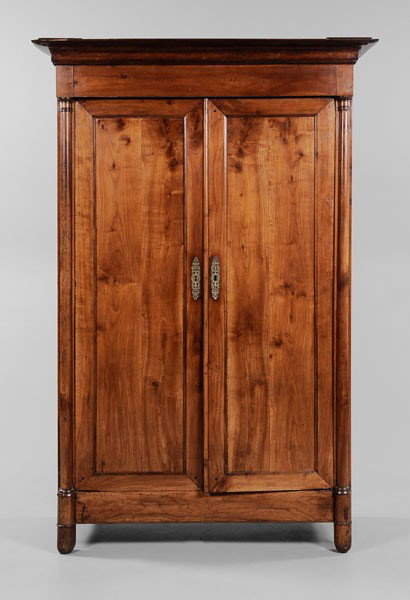 Provincial Empire Fruitwood Armoire: French, 19th century, removable pediment over two paneled doors set with cast bronze escutcheons and opening to a shelved interior, 85-1/4 x 50-1/2 x 21-3/4 in., scattered pest damage, warping to door