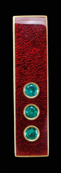 Enamel and Emerald Pendant: red enamel rectangular slide/pendant set with three round faceted emeralds, total estimated weight 1.14 cts., 23 kt. yellow gold mount with marks for J. Kimmel, 34.50 grams gross weight, 1/2 x 2-3/8 i