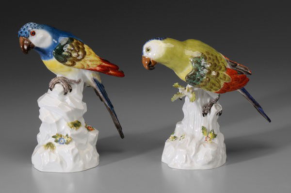 Two Meissen Parrots: German, 20th century, hand-painted, each perched on trunk embedded in rockwork, crossed swords mark, impressed "644a" and "644b", marked in pencil "ELX 98407", green plumage 7-1/2 in., blue 8-1/4 in.,