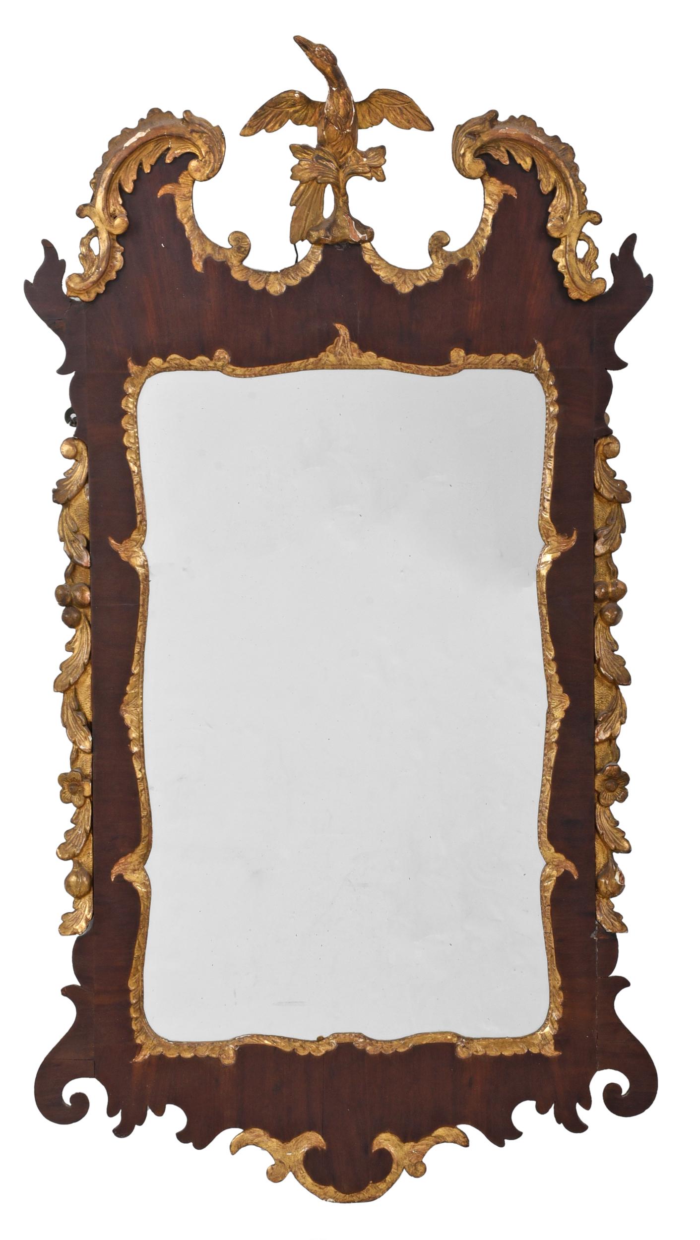 George III Mahogany and Giltwood Mirror: British, 18th century, with leaf and scroll crest centering a spread winged phoenix, on a leafy plinth, carved and gilt leaf and rosette streamers, carved and gilt plate surround and lower drop, 44 x 