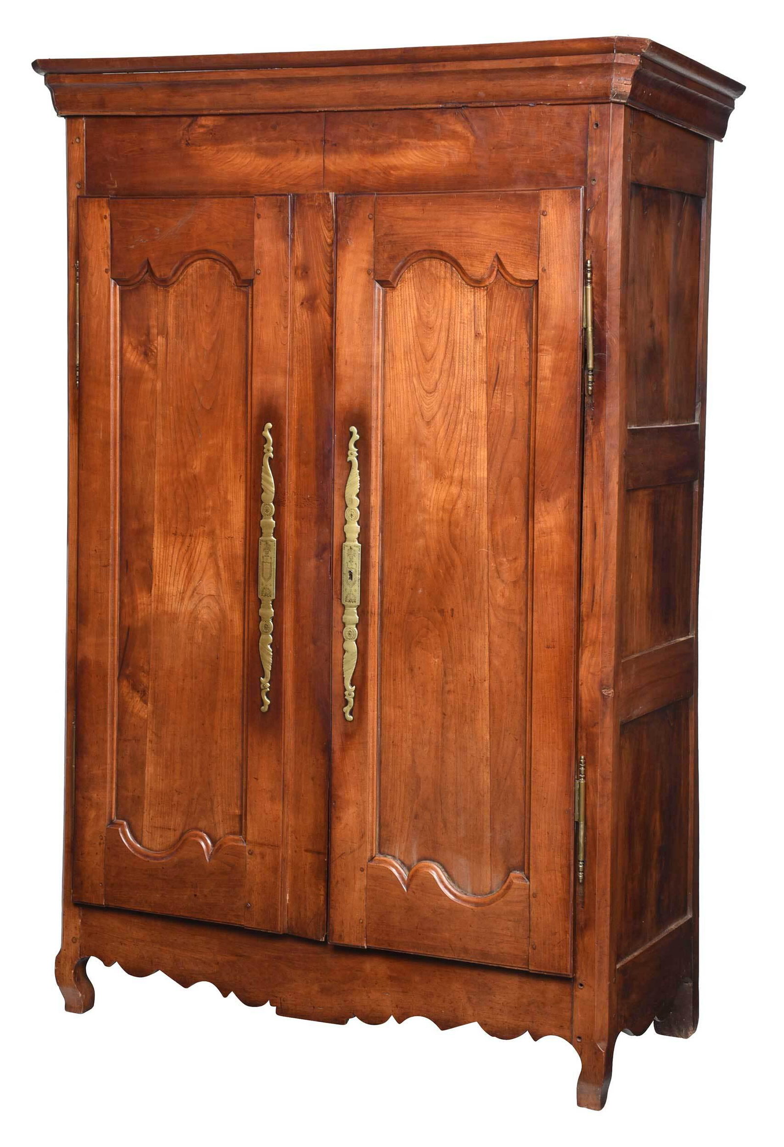 Provincial Louis XV Fruitwood Brass Mounted Armoire: French, 18th century, figured bookmatched fruitwood case with two arched and paneled doors with brass hinges and escutcheons, shelved interior, scalloped skirt, 82-1/2 x 51 x 24 in. Provenance: Proper