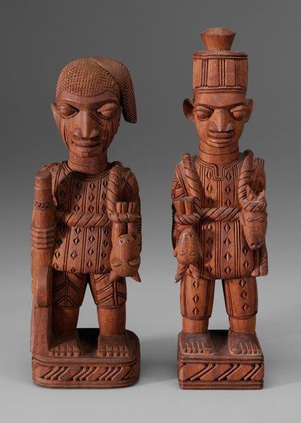 Lamidi Olonade Fakeye: (Nigerian, 1928-2009), Two Figures of Yoruba Hunters, incised signature on bottom "L.O. Fakeye", carved mahogany, one 14-3/4 in., two 15-1/2 in., one figure with loss to goat horn. Works by this artis