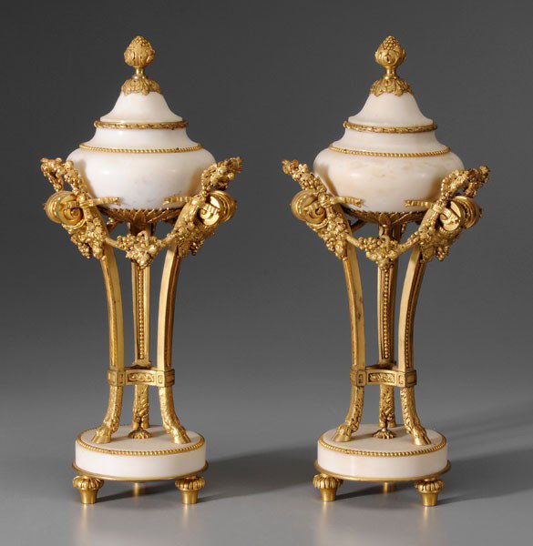 Pair Empire Marble [Cassolettes]: probably French, late 19th century, lidded vessels, each supported by three standards with hoof feet, gilt bronze mounts, 14 in., chips and repairs to one lid, several loose elements, one with slight 